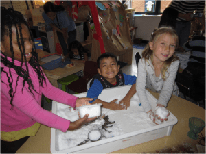 Playing with fake snow in a classroom sensory box
