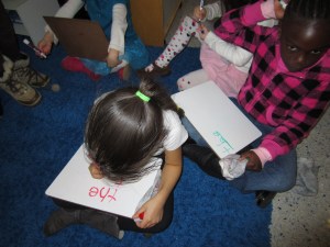 Writing on the white boards while we do morning message