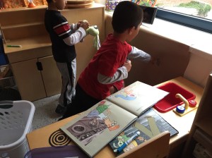 Acting out Knuffle Bunny in the "laundromat"