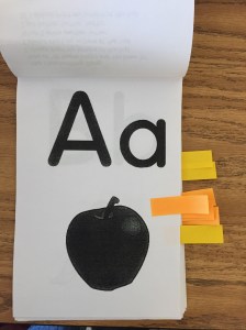 Our letter tracing books - known letters are marked with small Post-it notes.